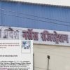 Building with a large pink sign in Hindi and a blue roof; foreground shows a 'Certificate of Registration' from the Madhya Pradesh Nurses Registration Council partially overlaying the image.