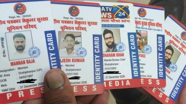 A hand holding several press identity cards with photos and Hindi text visible on each card.