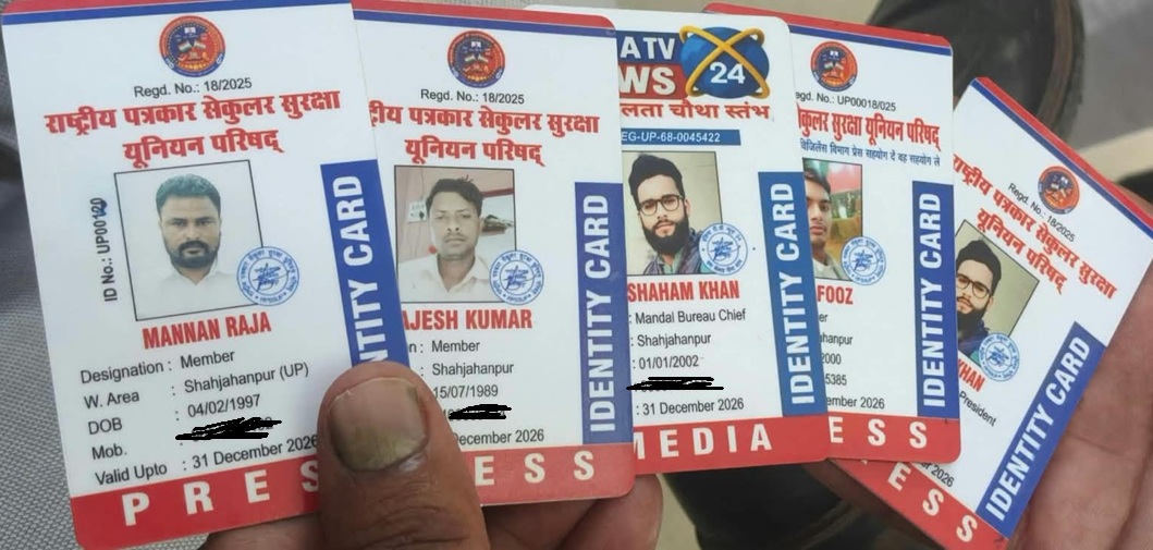 A hand holding several press identity cards with photos and Hindi text visible on each card.