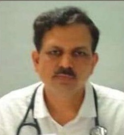 Portrait of a male doctor with a stethoscope around his neck, wearing a white coat and looking at the camera.