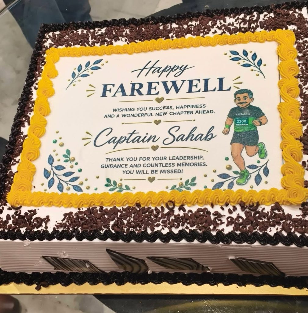 img_0826 | No. 1 Indian Media News Portal Farewell cake with an edible print reading 'Happy FAREWELL Captain Sahab,' yellow piped border and a running figure on the right.