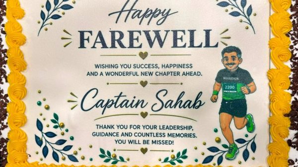 Celebration cake with yellow piped border saying 'Happy Farewell' to Captain Sahab, featuring a cartoon runner and floral decorations.