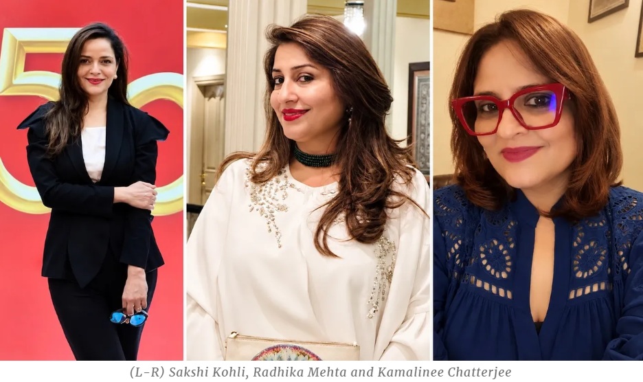 Three women posing at an event: Sakshi Kohli (left) in a black suit, Radhika Mehta (center) in a white embellished top, Kamalinee Chatterjee (right) in a blue lace top with red glasses.