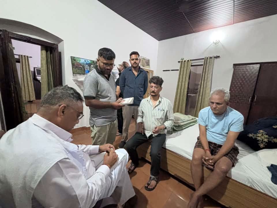 kajal kotha | No. 1 Indian Media News Portal Group of men in a bedroom, one seated in white traditional clothing showing something on his phone to others.