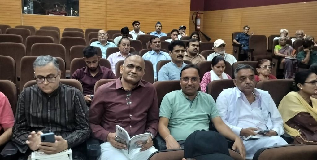 kajal kotha_1 | No. 1 Indian Media News Portal Audience seated in a conference hall, mixed group of men and women facing the stage in brown theater seats.