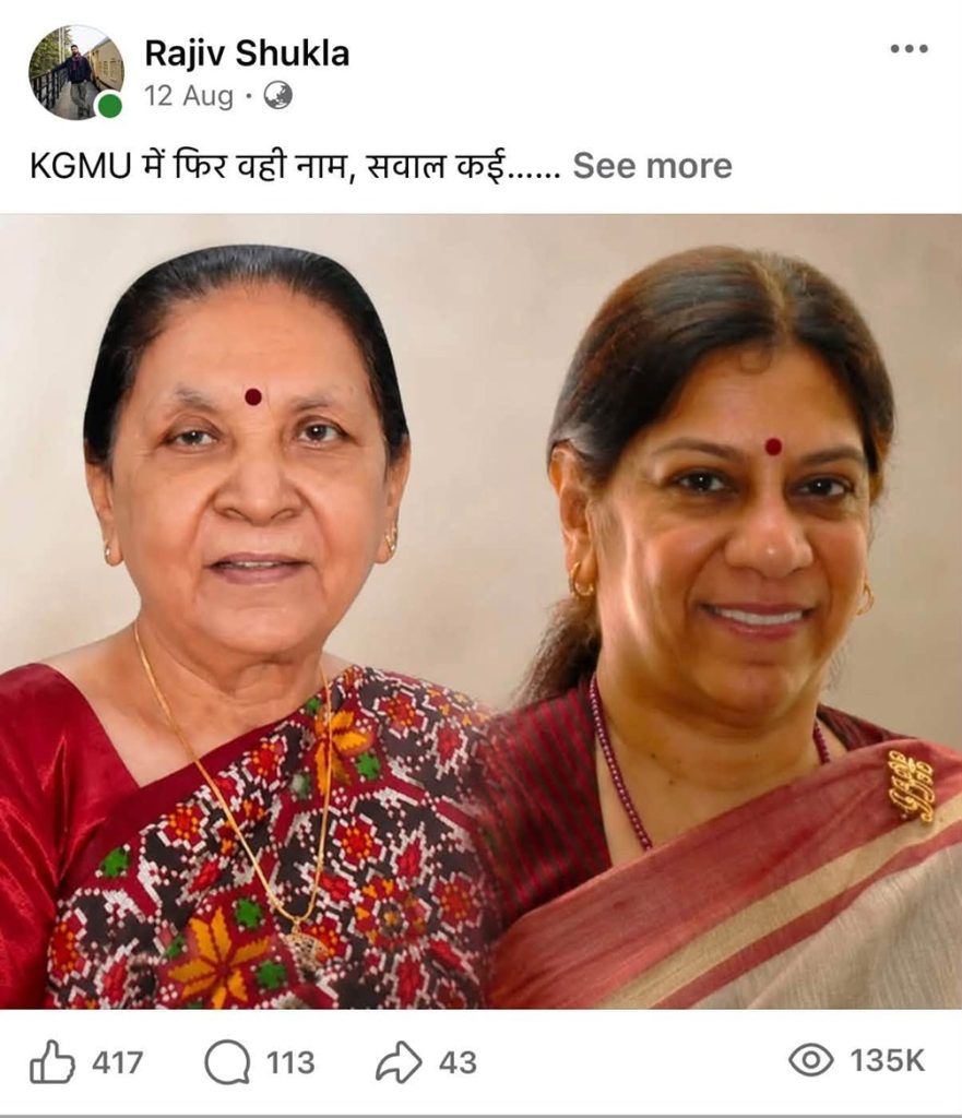 Two Indian women in sarees posing together, both wearing gold jewelry and red bindis on their foreheads.