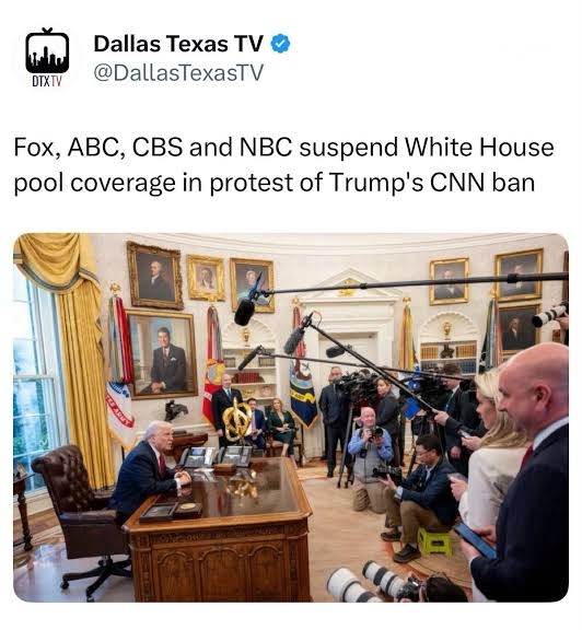 President sits at the Resolute Desk in the White House Oval Office as journalists and cameras surround him for protest coverage of Trump’s CNN ban.
