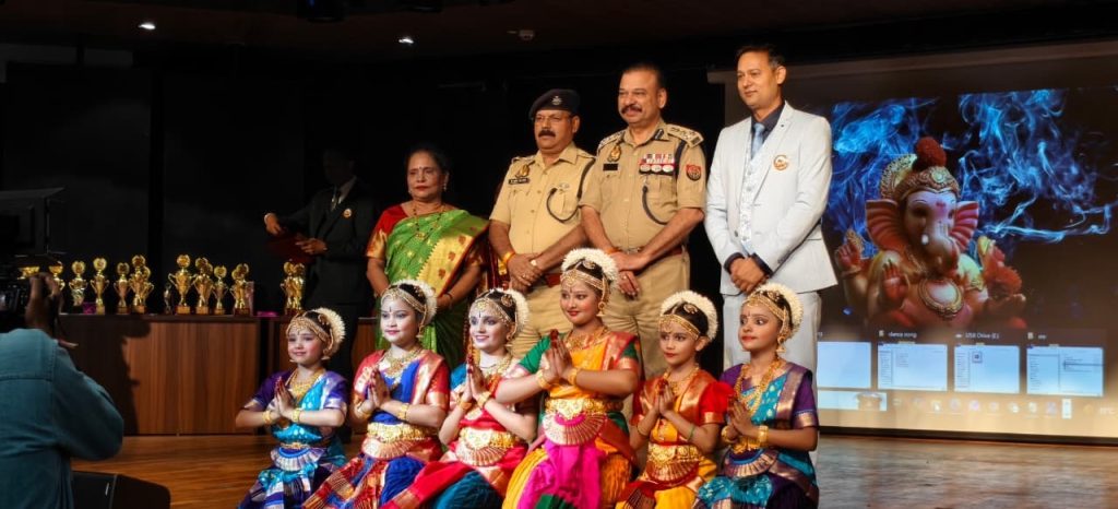 7170c986-0550-4385-9306-a055d968c213 | No. 1 Indian Media News Portal Young girls in colorful Indian dance costumes pose on stage, with police officers and officials behind them and trophies to the left.