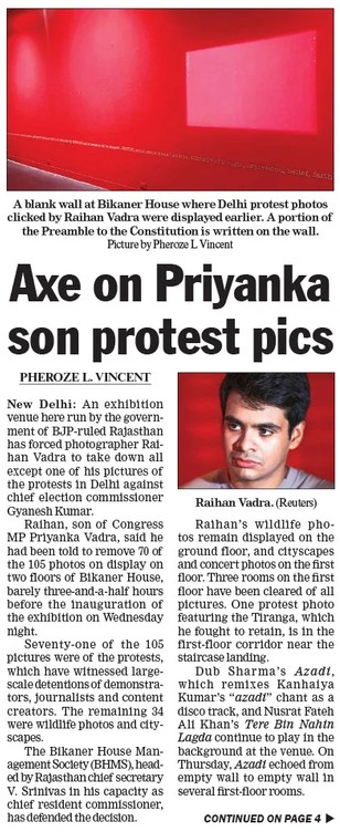 Newspaper article about Priyanka Gandhi protest photos, showing a blank red wall and a portrait of Raihan Vadra.