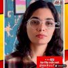 Video thumbnail showing a woman with round glasses speaking, with a Hindi news headline about Neha Singh Rathore and ABP News alleging fake news in red ticker text at the bottom.