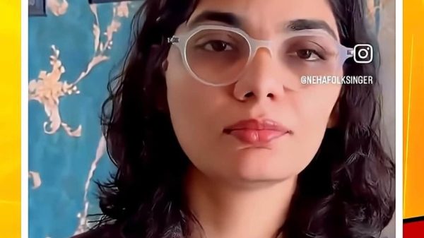 Video thumbnail showing a woman with round glasses speaking, with a Hindi news headline about Neha Singh Rathore and ABP News alleging fake news in red ticker text at the bottom.