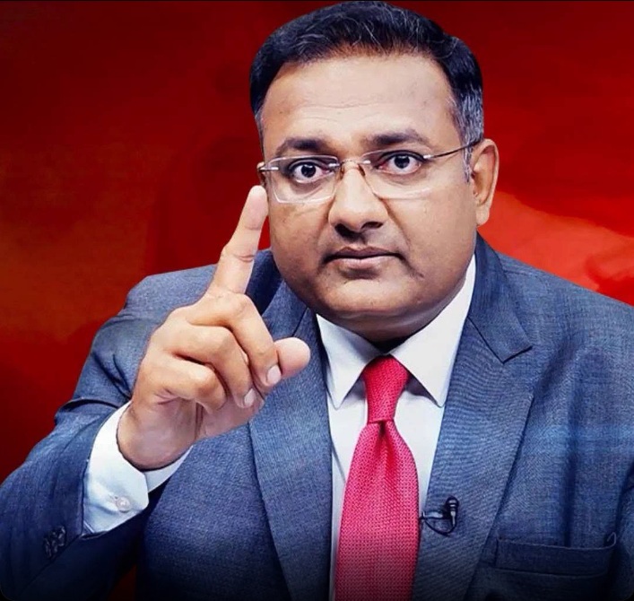 atul agarwal | No. 1 Indian Media News Portal Professional man in a gray suit and red tie raises his index finger as if making a point against a red background.