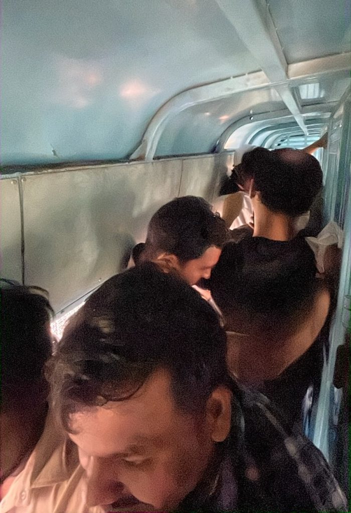 detain | No. 1 Indian Media News Portal Crowded airplane cabin with passengers standing in the narrow aisle, facing different directions, heads down.