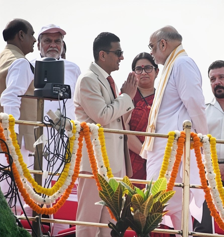 dyc | No. 1 Indian Media News Portal Group of Indian officials on a decorated stage; two men greet with a namaste as garlands drape the railing.