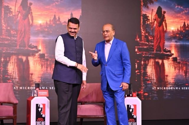 img_1947 | No. 1 Indian Media News Portal Two men in formal attire shake hands on a stage with India Today branding and a sunset backdrop.