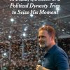 The New York Times headline over a man in a blue polo speaking into a microphone at a crowded stadium.