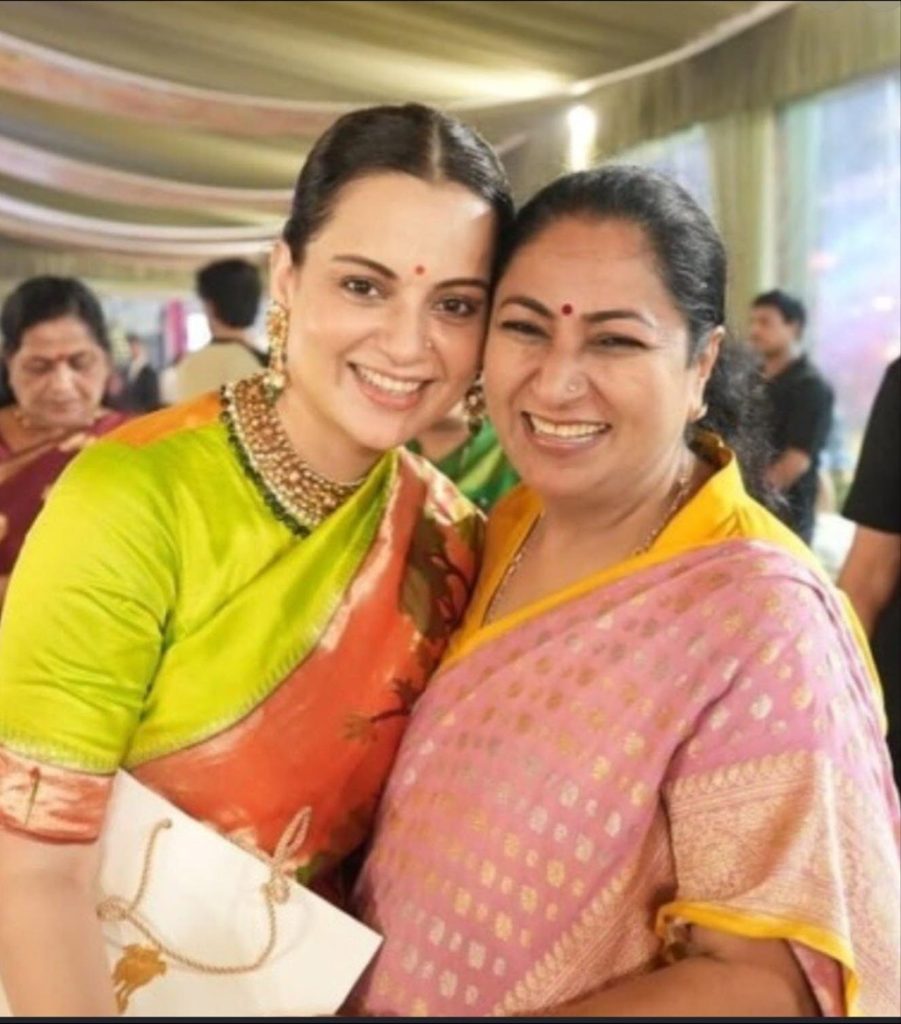 Screenshot | No. 1 Indian Media News Portal Two Indian women in colorful sarees smiling and posing together at a festive event.