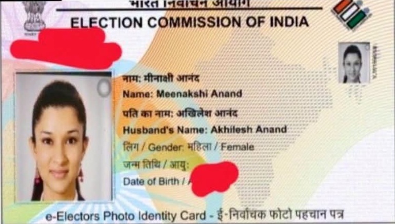 Election Commission of India voter ID card with a passport photo of Meenakshi Anand, showing her name, husband's name Akhilesh Anand, and gender female.