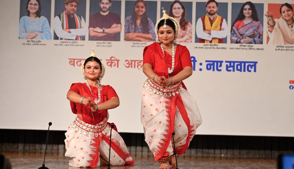 mera rang_2 | No. 1 Indian Media News Portal Two women in red and white traditional Indian dance costumes perform a duet on stage with ornate jewelry and headdresses.