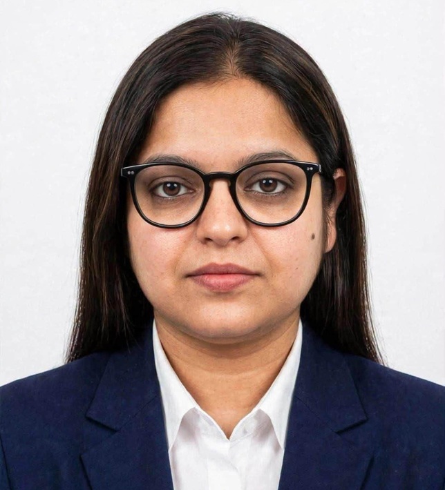 mrinal | No. 1 Indian Media News Portal Professional headshot of a woman with dark hair and glasses, wearing a navy blazer and white shirt, facing the camera with a neutral expression
