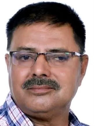 naresh | No. 1 Indian Media News Portal Portrait of a middle-aged man with glasses and a mustache, wearing a plaid shirt, looking at the camera.
