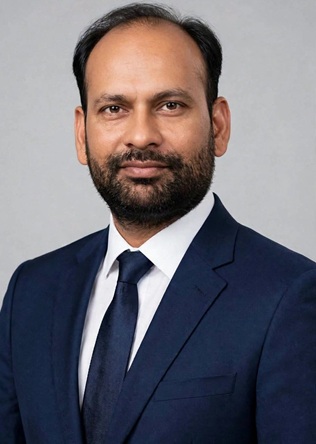 rishikesh pandey aaj | No. 1 Indian Media News Portal Professional headshot of a man in a navy suit and tie looking at the camera.