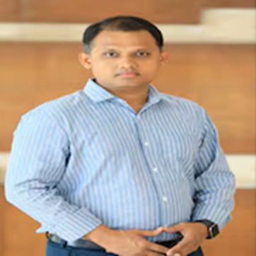 ritvick | No. 1 Indian Media News Portal Man in a light blue striped shirt standing indoors with hands clasped at the waist.