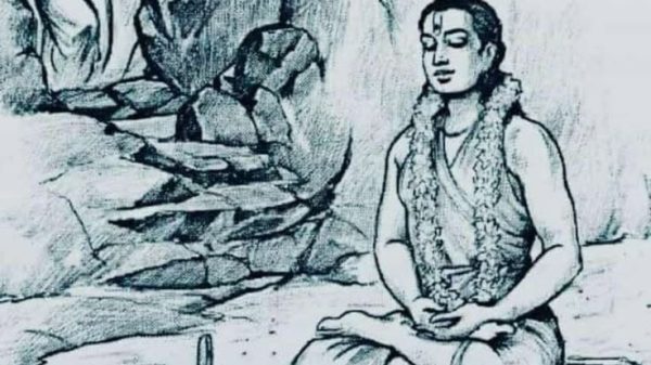 A guru sits cross‑legged in meditation on a rock with a garland around the neck, as people enter a cave behind him.